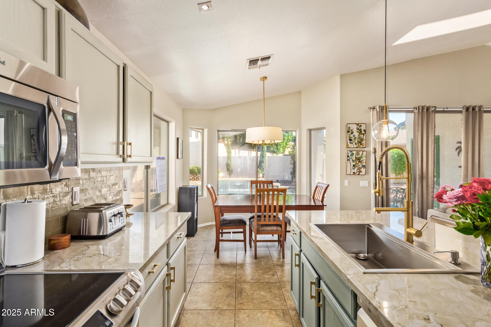 4038 West Alex Loop Phoenix, AZ 85083 - Photo 2 of 36 a kitchen with granite countertop a sink a counter top space appliances and cabinets
