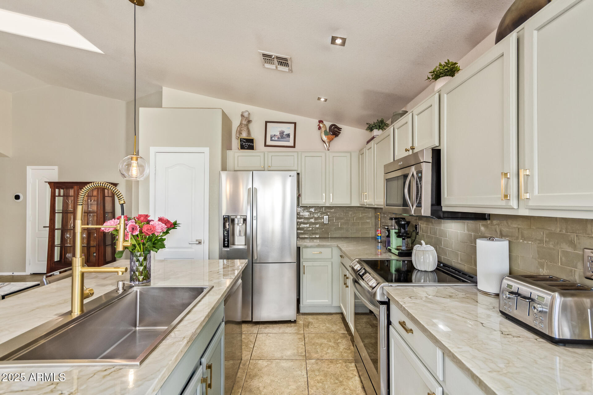 4038 West Alex Loop Phoenix, AZ 85083 - Photo 3 of 37 a kitchen with granite countertop a sink stainless steel appliances a counter top space and cabinets