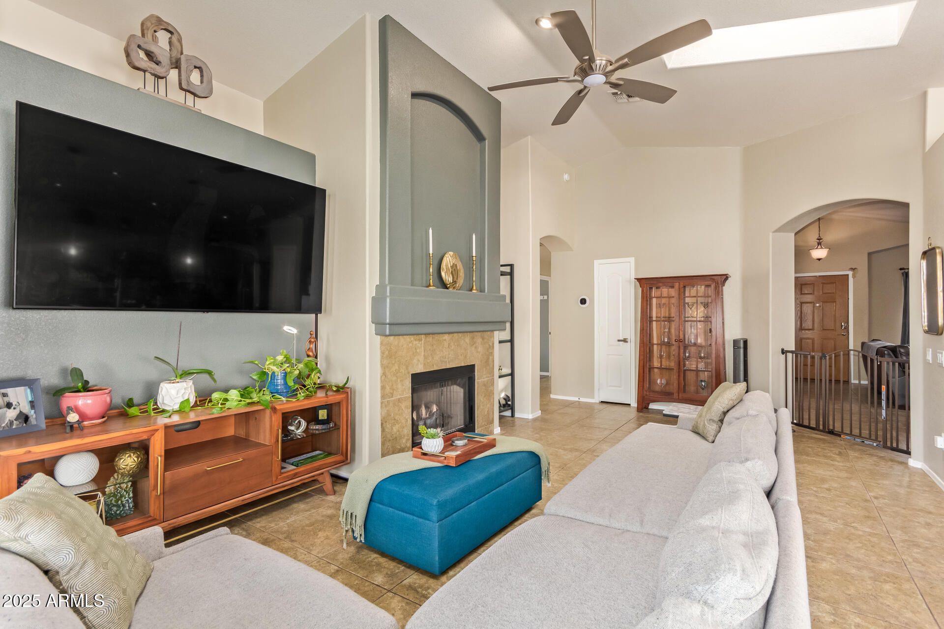 4038 West Alex Loop Phoenix, AZ 85083 - Photo 6 of 37 a living room with furniture a flat screen tv and a fireplace