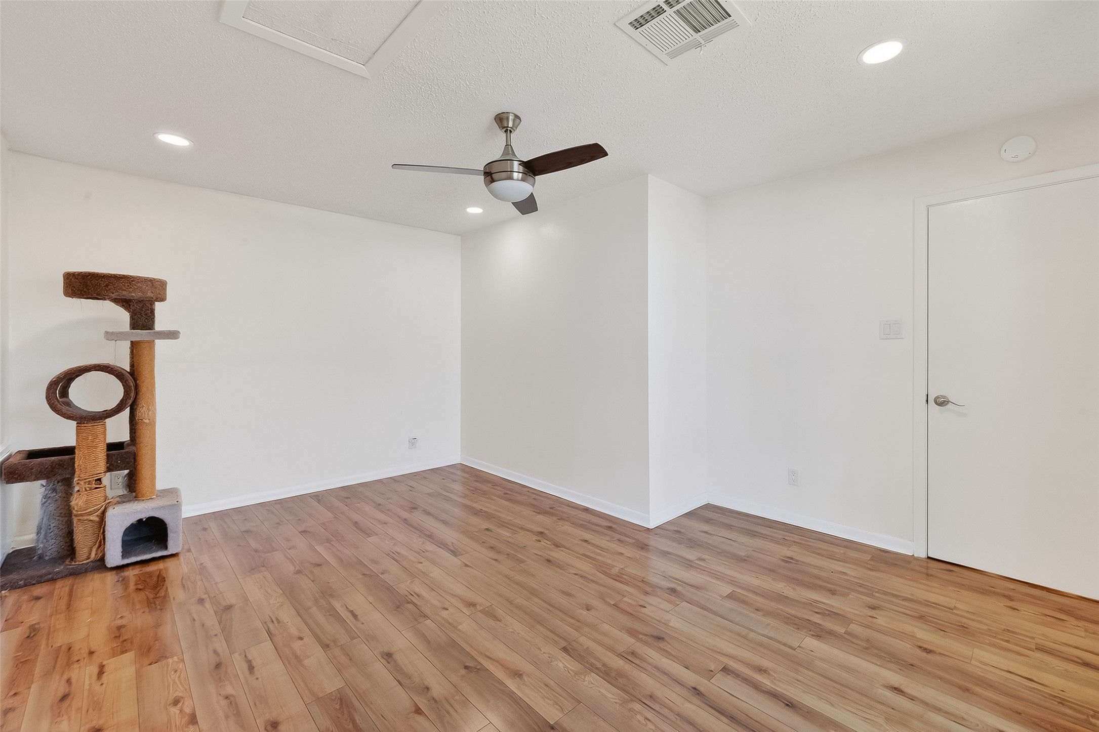 7014 Concho Street Houston, TX 77074 - Photo 25 of 46 Primary bedroom has laminate wood floors, recessed lights and a ceiling fan.