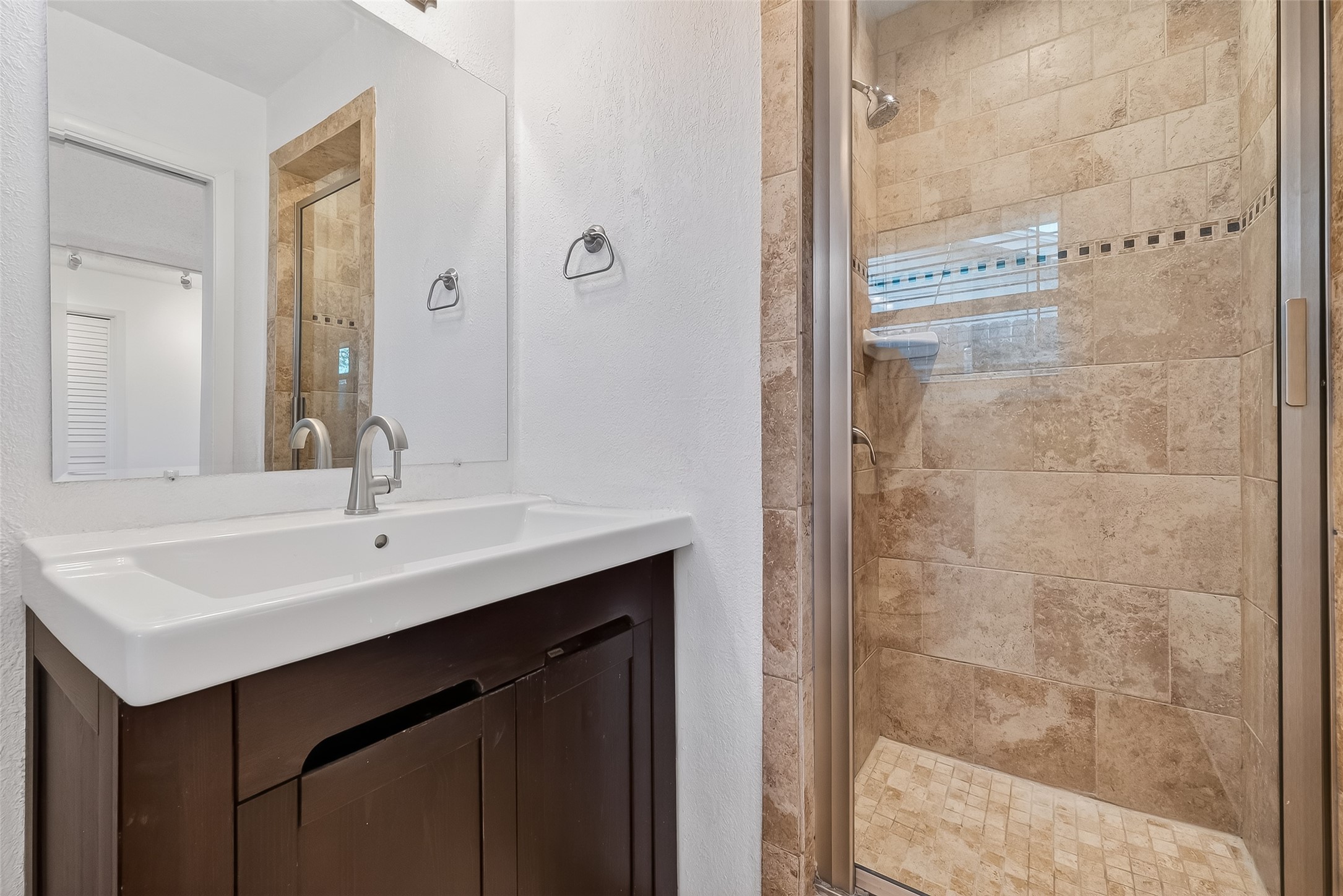 7014 Concho Street Houston, TX 77074 - Photo 31 of 46 En suite bath has a shower and glass door.