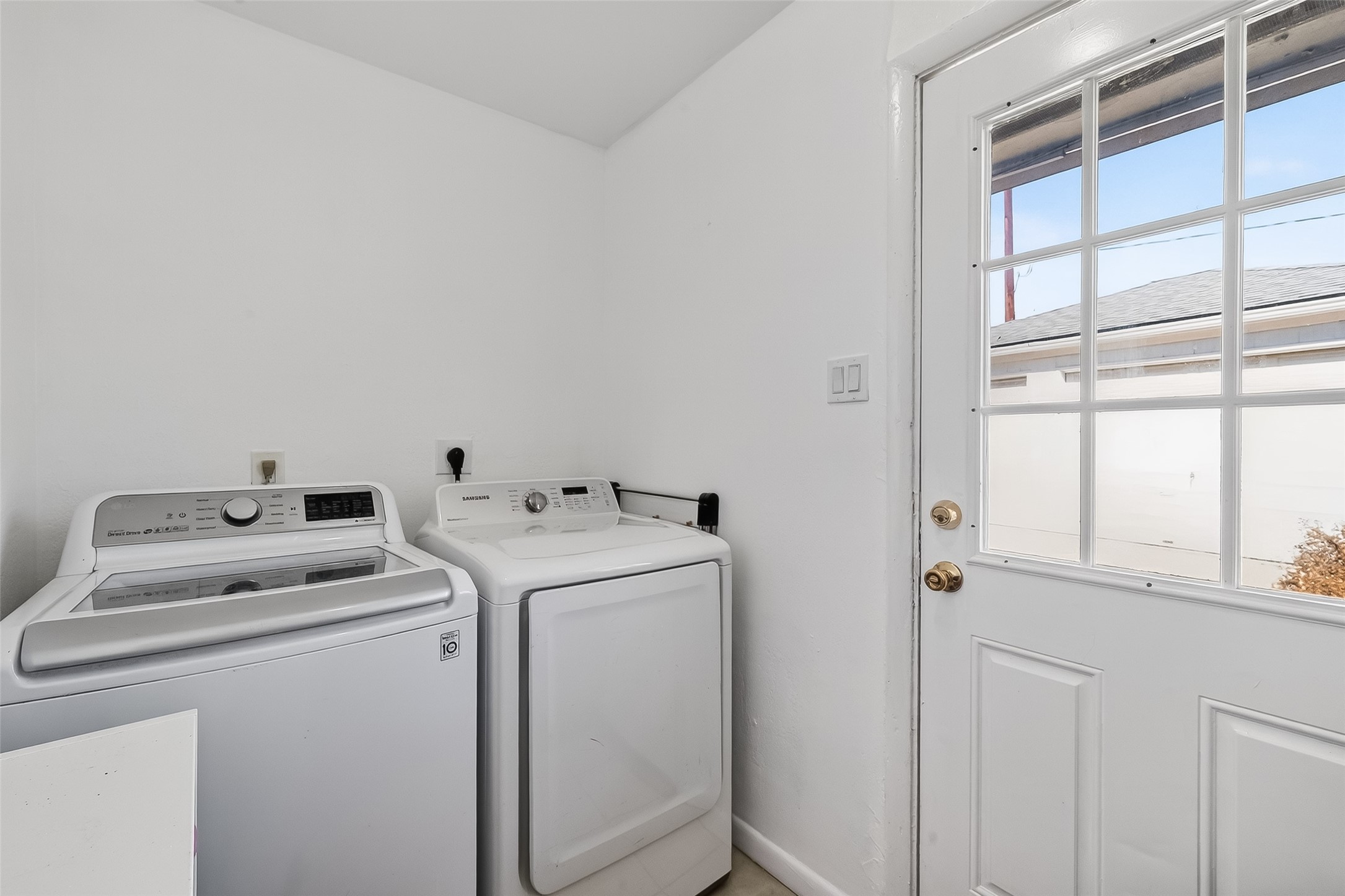 7014 Concho Street Houston, TX 77074 - Photo 38 of 46 Utility room with a door with glass to allow natural light. The washing machine and dryer are included.