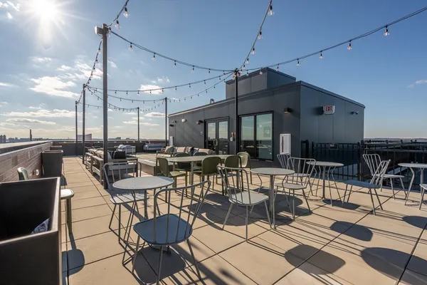 a patio with a table chairs and a barbeque