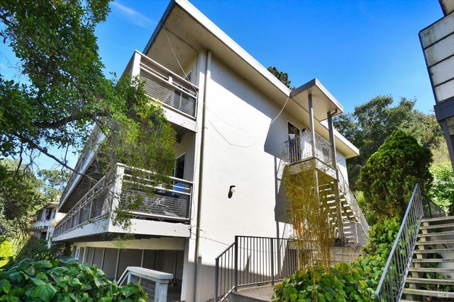 a view of a house with a tree