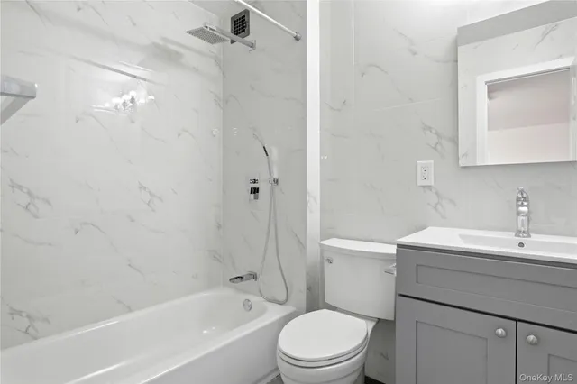 a bathroom with a shower a toilet and a sink