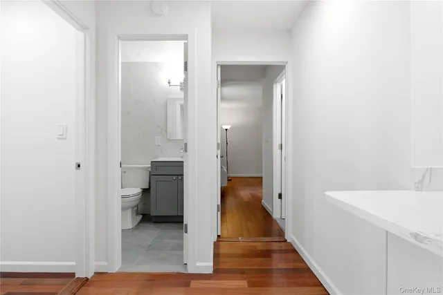 a view of a hallway with a dining table and chandelier