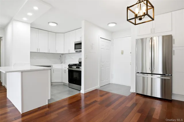 a kitchen with wooden floors and white appliances