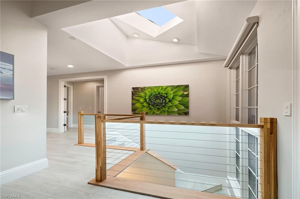 1160 Clam Court, Unit 3 Naples, FL 34102 - Photo 13 of 50 a view of a hallway with wooden floor and windows