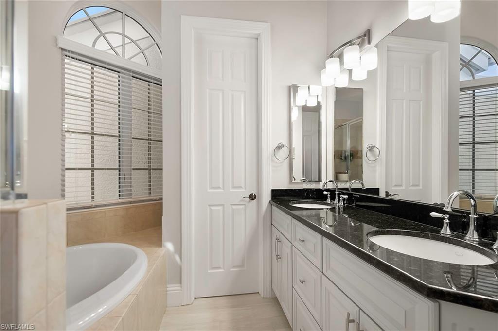 1160 Clam Court, Unit 3 Naples, FL 34102 - Photo 17 of 50 a bathroom with a granite countertop tub sink and mirror