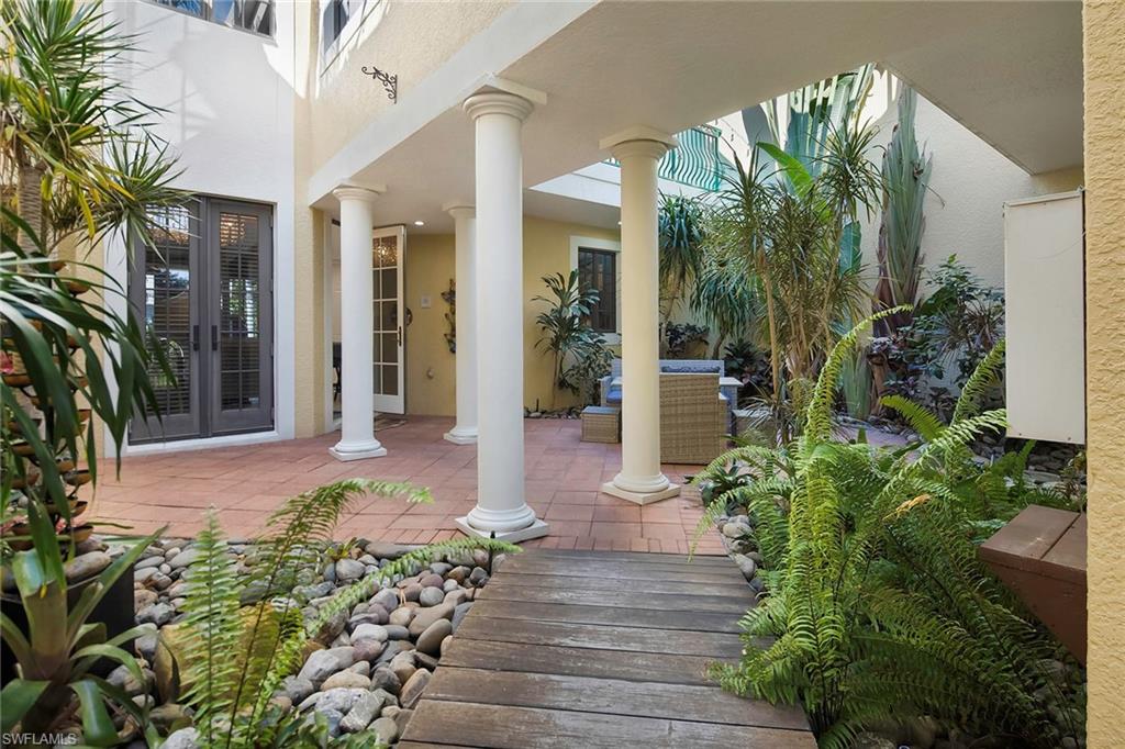 1160 Clam Court, Unit 3 Naples, FL 34102 - Photo 2 of 50 a front view of a house with a yard