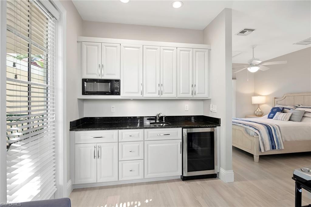 1160 Clam Court, Unit 3 Naples, FL 34102 - Photo 21 of 50 a kitchen with stainless steel appliances granite countertop a stove a sink and white cabinets