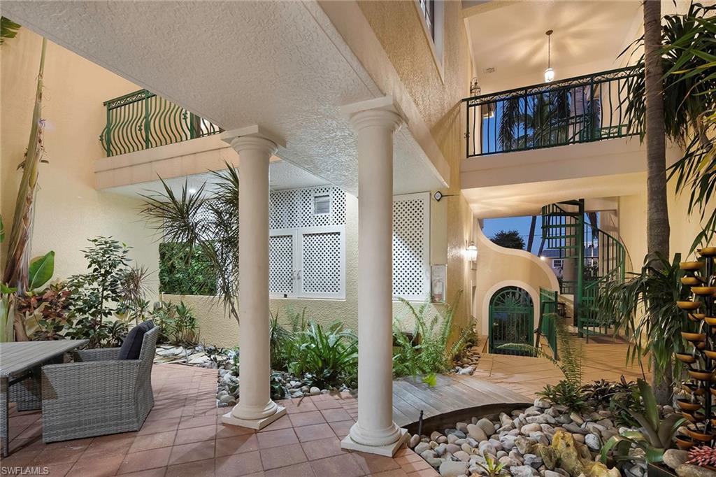 1160 Clam Court, Unit 3 Naples, FL 34102 - Photo 23 of 50 a front view of a house with garden