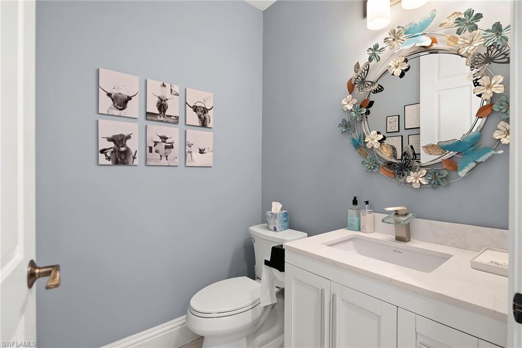 1160 Clam Court, Unit 3 Naples, FL 34102 - Photo 29 of 50 a bathroom with a sink mirror vanity and toilet