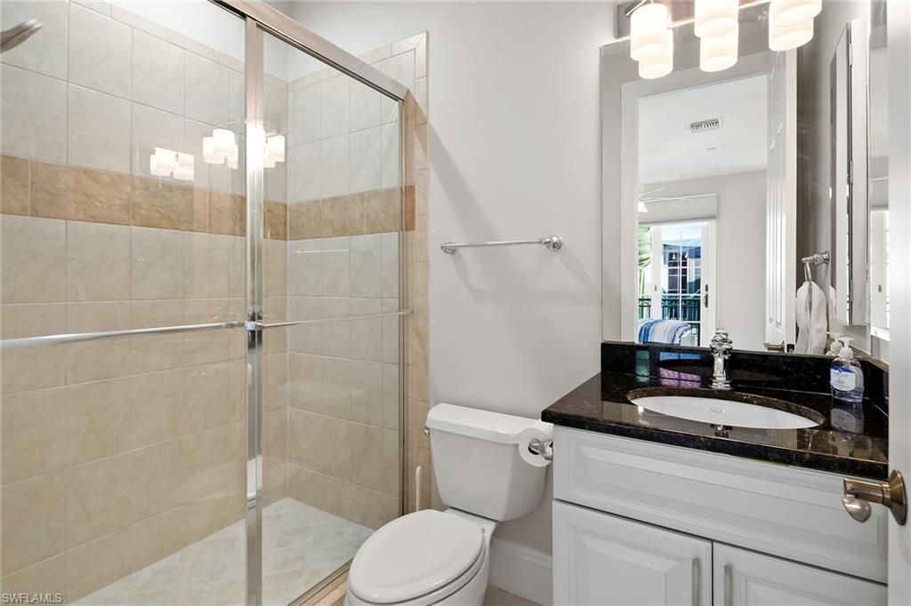 1160 Clam Court, Unit 3 Naples, FL 34102 - Photo 34 of 50 a bathroom with a granite countertop sink a toilet and shower