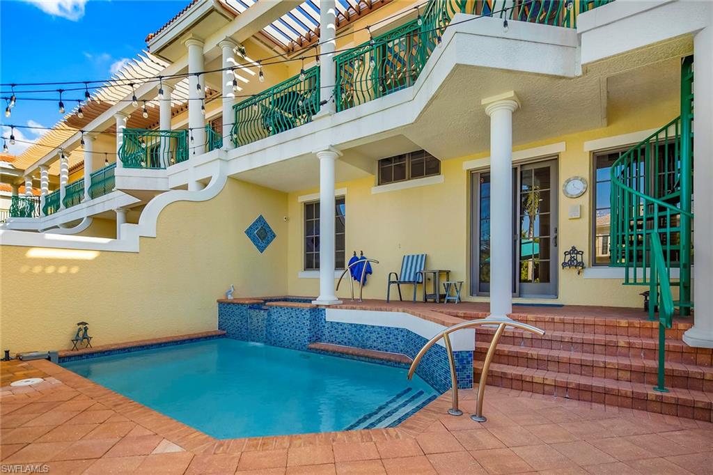 1160 Clam Court, Unit 3 Naples, FL 34102 - Photo 37 of 50 a backyard of a house with sofas table and chairs