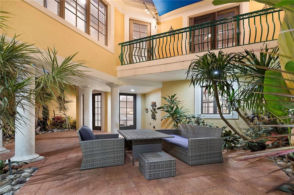 1160 Clam Court, Unit 3 Naples, FL 34102 - Photo 5 of 50 a view of a patio with couches and potted plants