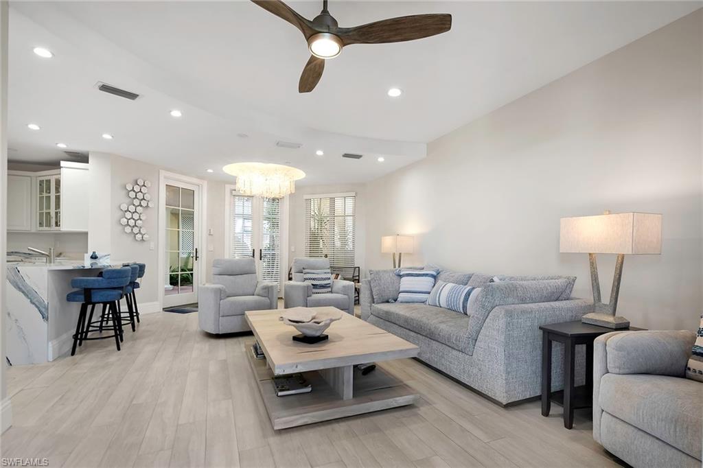 1160 Clam Court, Unit 3 Naples, FL 34102 - Photo 9 of 50 a living room with furniture and a lamp