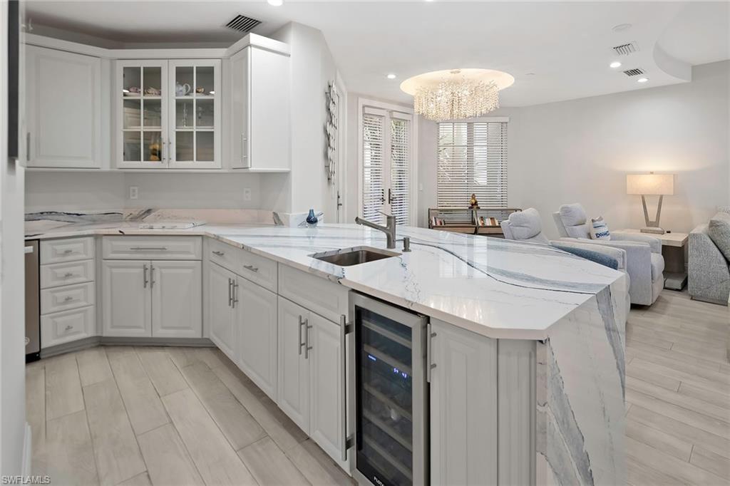 1160 Clam Court, Unit 3 Naples, FL 34102 - Photo 10 of 50 a kitchen with sink and mirror