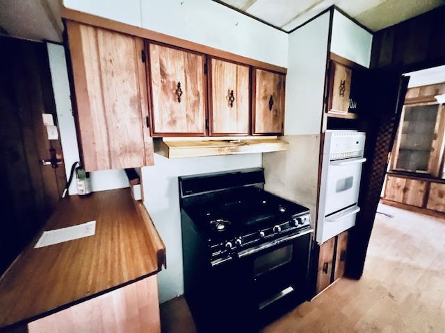 5208 9th Street Keyes, CA 95328 - Photo 5 of 35 a kitchen with stainless steel appliances granite countertop a stove a refrigerator and a fireplace