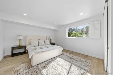 a bedroom with a large bed and a window