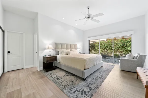 a spacious bedroom with a bed and a couch