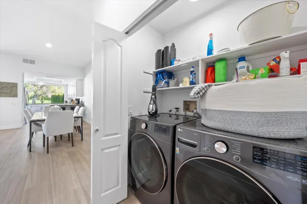 a utility room with dryer washer and storage