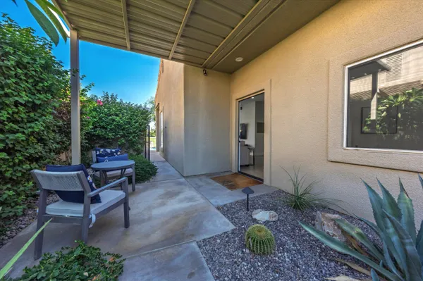 a backyard of a house with outdoor seating