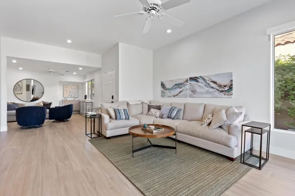 a living room with furniture and a chandelier
