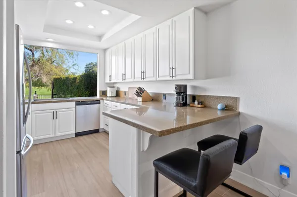 a kitchen with a sink cabinets and window