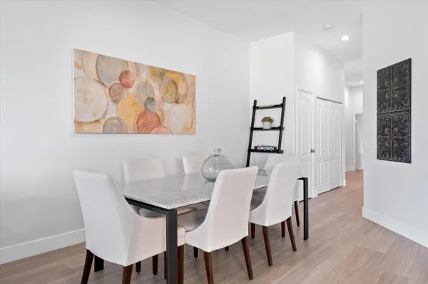 a view of a dining room with furniture and wooden floor