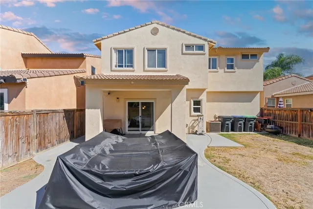 a kitchen with stainless steel appliances a stove a refrigerator a sink a dining table and chairs