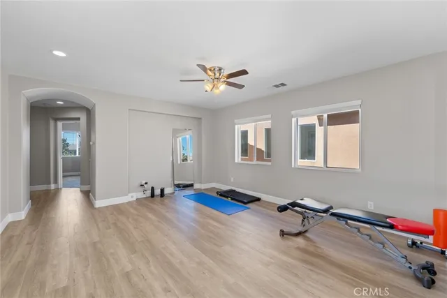 a bedroom with a bed and a ceiling fan