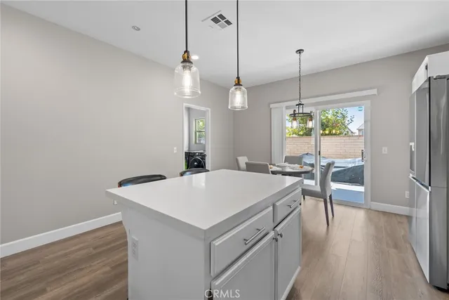 a dinning room and kitchen with stainless steel appliances