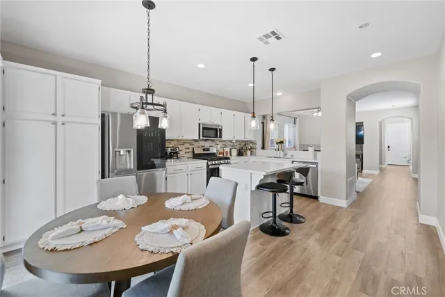 a kitchen with stainless steel appliances a sink stove and cabinets