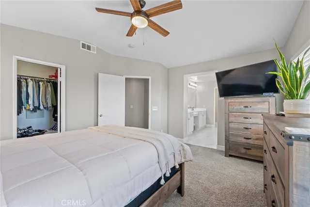 a spacious bathroom with a double vanity sink a mirror and shower