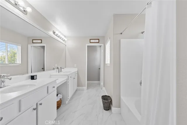 a white bath tub sitting next to a shower
