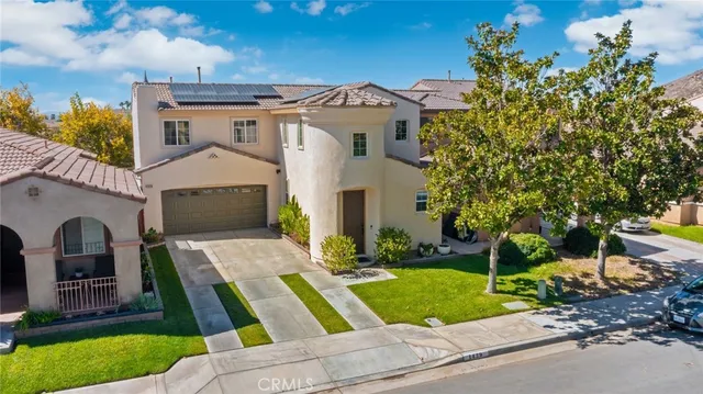 an aerial view of a house with large trees