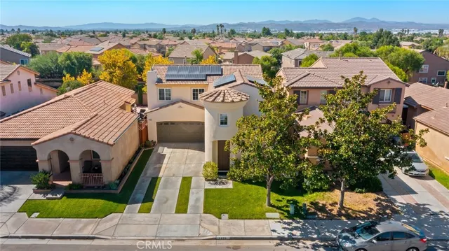 an aerial view of a house with a swimming pool