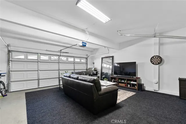 a living room with lots of furniture and white walls