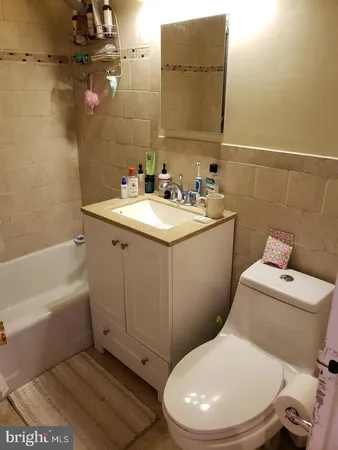 a bathroom with a sink a toilet and bathtub