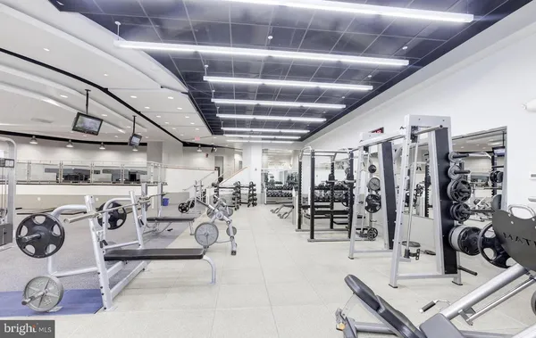 a living room with lots of furniture and a view of kitchen