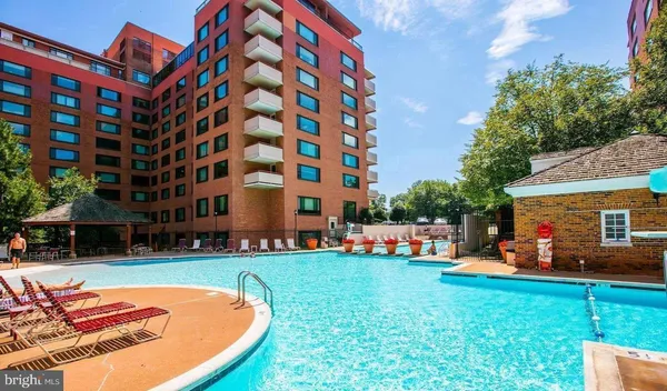 a backyard of a building with barbeque oven table and chairs
