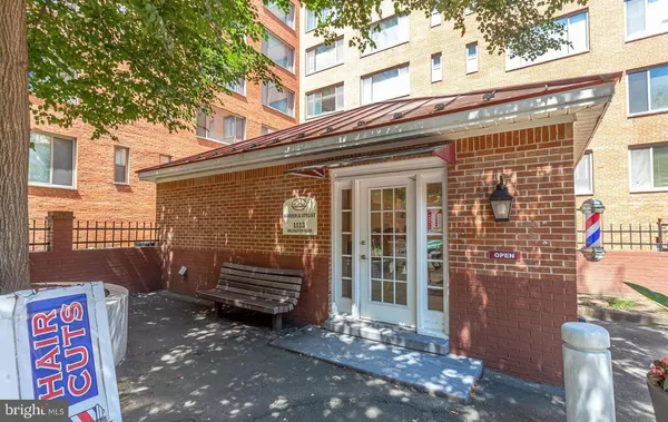 a front view of a house with a tree