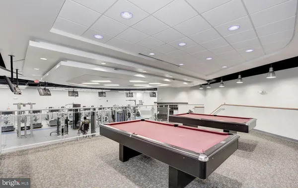 a room with gym equipment and a table