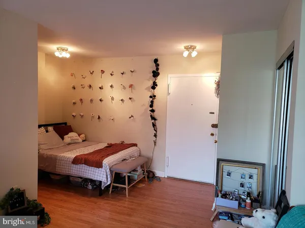 a room with a bed and wooden floor