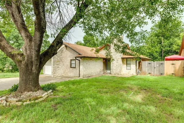 a front view of house with yard and trees