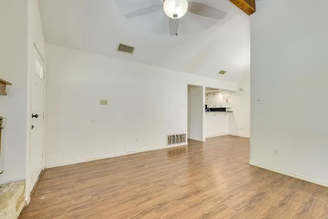 a view of an empty room and wooden floor