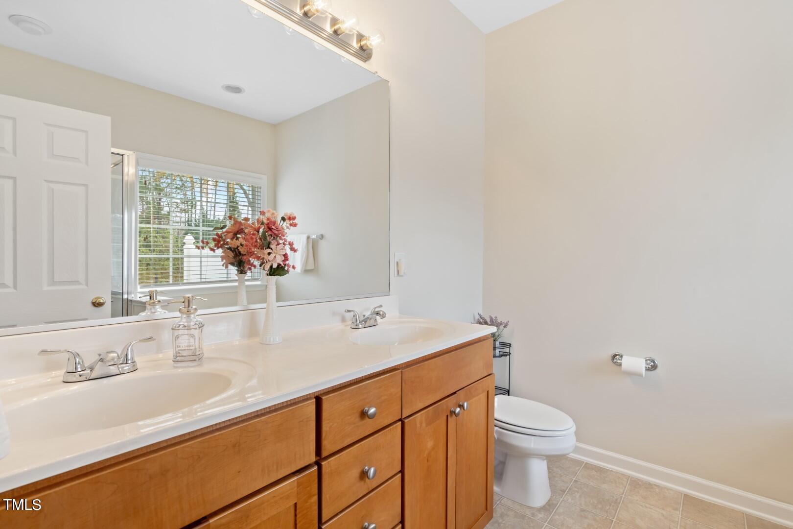 12219 Fox Valley Street Raleigh, NC 27614 - Photo 17 of 36 a bathroom with a granite countertop sink mirror and toilet