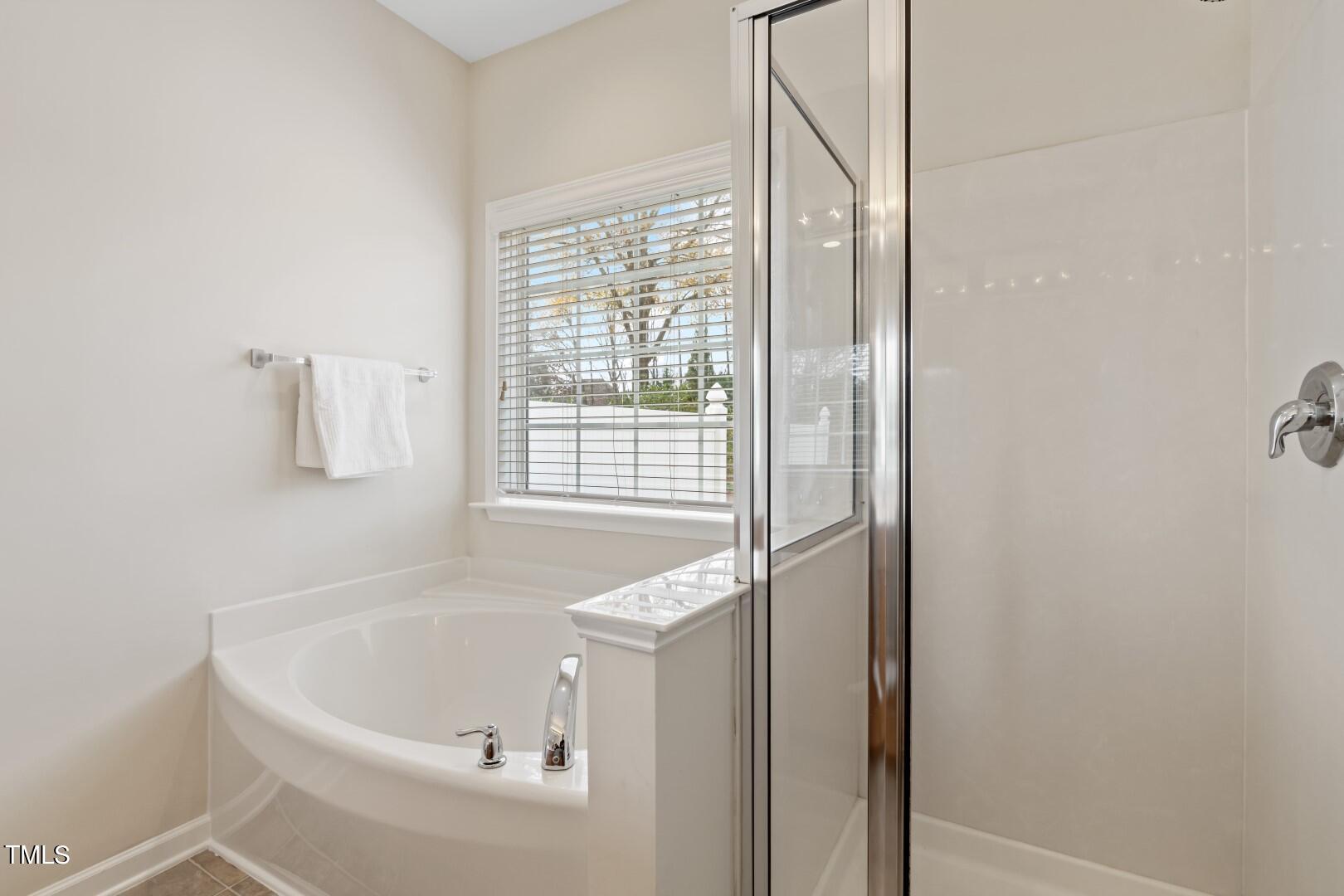 12219 Fox Valley Street Raleigh, NC 27614 - Photo 18 of 36 a white bath tub sitting next to a window