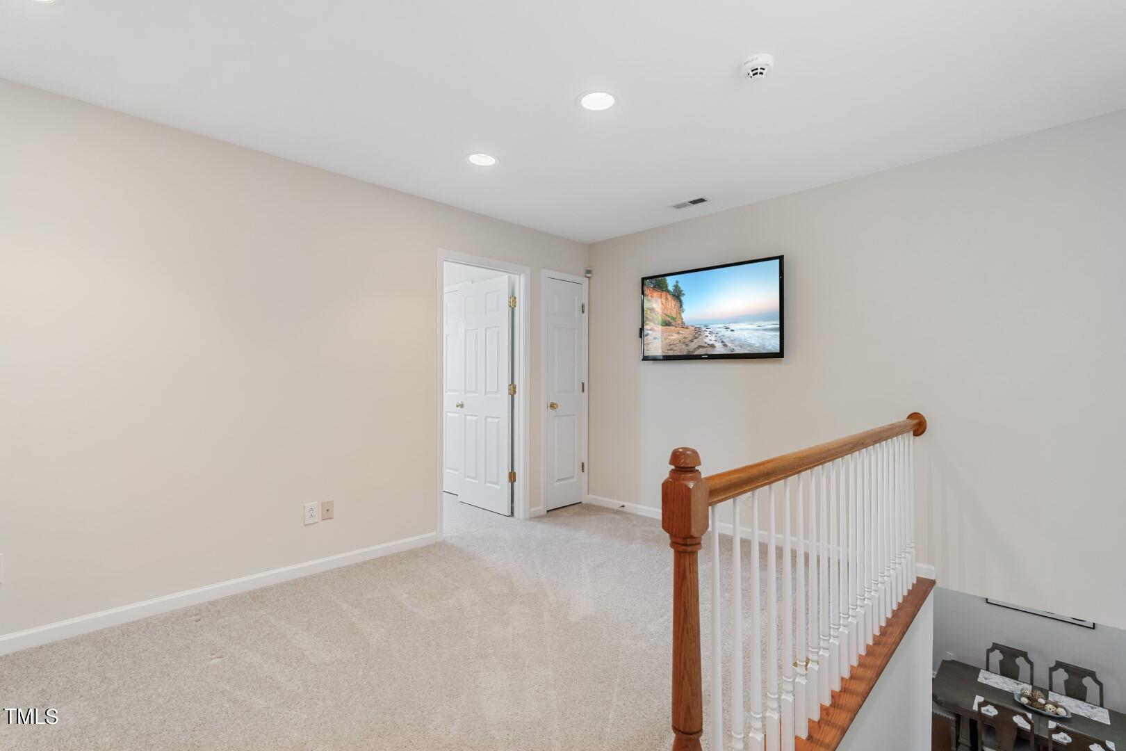 12219 Fox Valley Street Raleigh, NC 27614 - Photo 23 of 36 a view of a hallway with paintings on the wall
